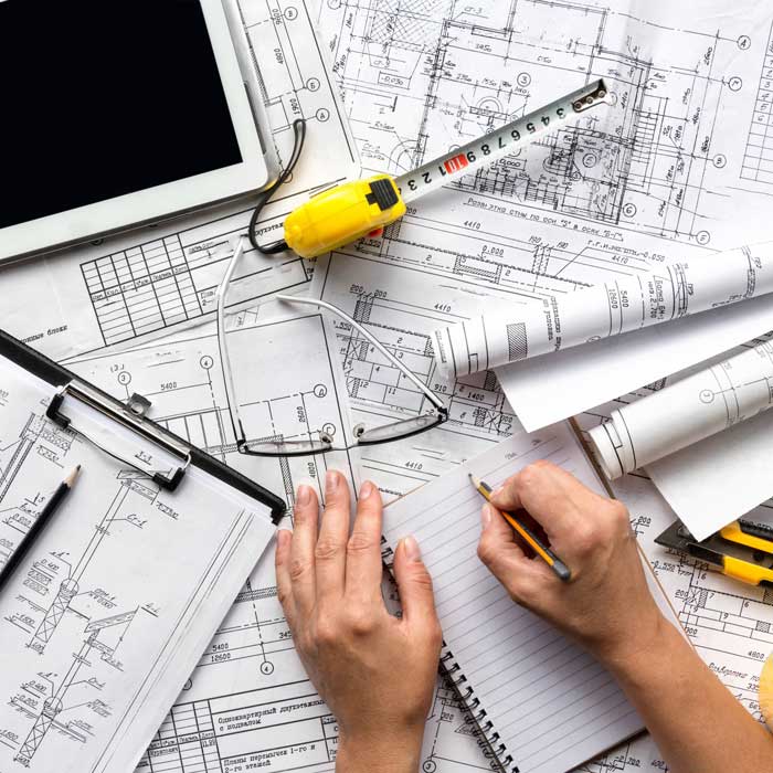 architect design working drawing sketch plans blueprints and making architectural construction model